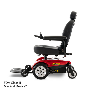 A red and black Pride Mobility Jazzy Select® Powerchair with high backrest, armrests, footrest, and "Jazzy" branding on the side. Text in the corner reads: FDA Class II Medical Device*.