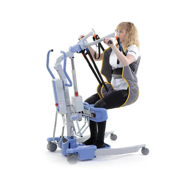 A woman sits in a Joerns Sling for Patient Lift Models Ascend, Elevate & Journey, secured with an adjustable waist strap as the blue and gray lift with wheels supports her upper body to assist with mobility transfers.