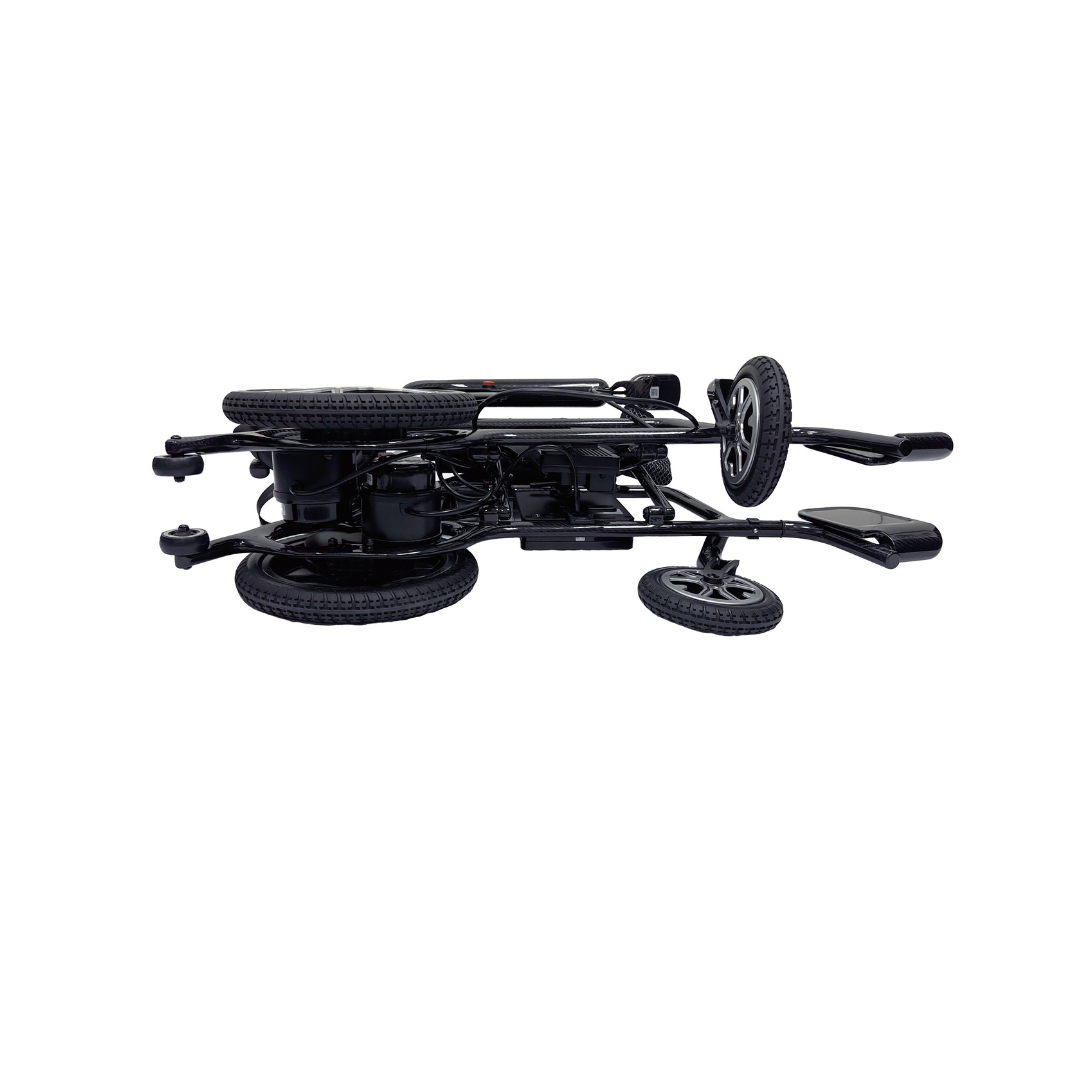 A folded Journey Air Elite Folding Carbon Fiber Powerchair weighing only 29 lbs lies on its side, showcasing its travel-friendly design with visible wheels and handles, perfect for easy storage or transport.