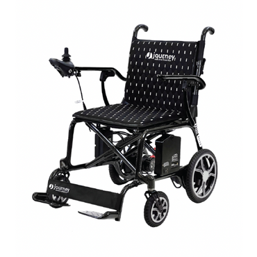 The Journey Air Elite Folding Carbon Fiber Powerchair, weighing only 29 lbs, boasts a travel-friendly black design with a joystick controller, cushioned seat, and Journey branding on the backrest. It features large rear wheels, small front wheels, and a footrest for comfortable mobility support.