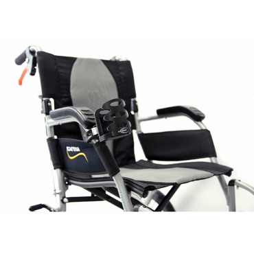 A sleek, lightweight wheelchair with foldable armrests features a removable universal cup holder and handbrake. The Karma logo is on the backrest, ensuring ease during travel and storage.
