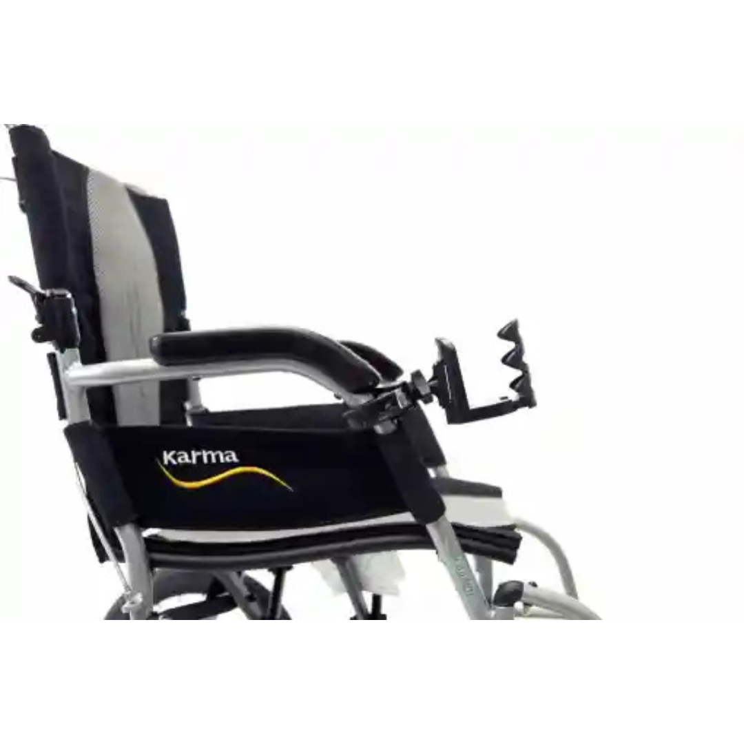 The image shows a close-up side view of a lightweight mobility device with a black fabric seat and backrest, featuring the Karma logo. It includes metal curved armrests, footrests, and an adjustable Karman Cup Holder for Mobility Aids, set against a white background.