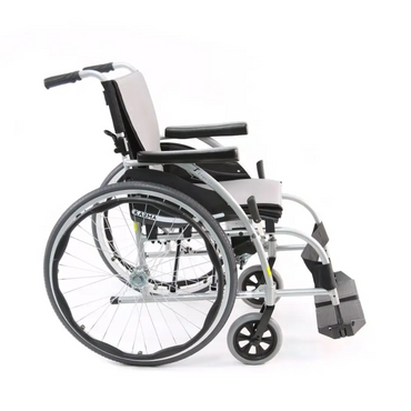 Side view of the Karman S-Ergo 105 Wheelchair, featuring S-shaped ergonomic seating. This lightweight model has large rear wheels and smaller front ones, a black seat with armrests and footrests, all set in a sleek silver frame.