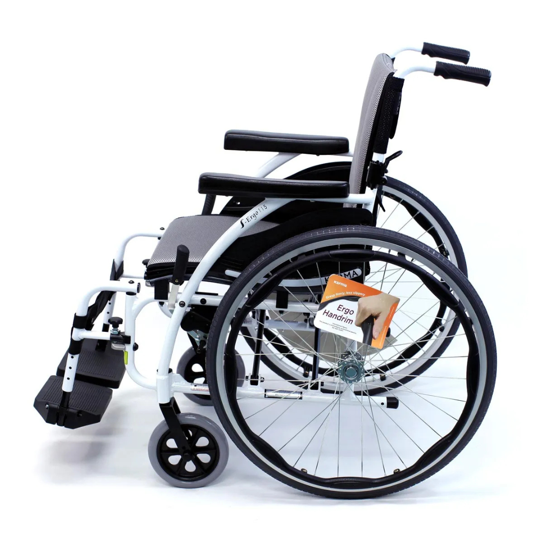 Side view of the Karman S-Ergo 115 Ultra Lightweight Ergonomic Wheelchair, weighing just 25 lbs. It features large rear wheels, small front wheels, Ergo Handrim labeled wheel, and black ergonomic seating with armrests and footrests for maximum comfort and support.