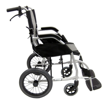 Side view of the Karman Ergo Lite Ultra Lightweight Ergonomic Transport Chair, weighing only 18 lbs, with a silver frame, black seat, and armrests. It features large rear wheels and smaller front ones for easy transport and maneuverability.