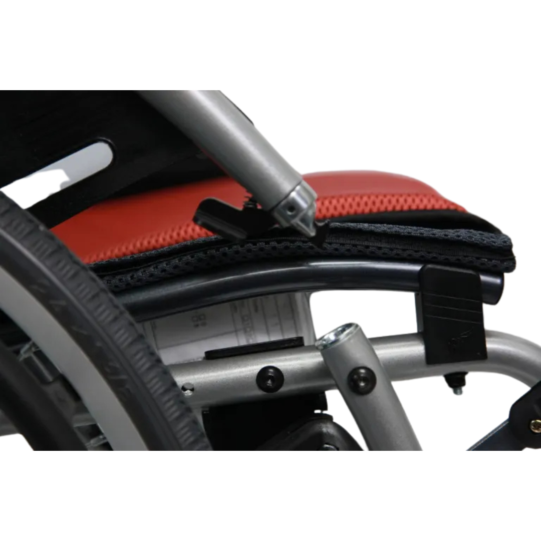 Close-up of a Karman S-Ergo 125 Wheelchair featuring a cushioned seat with a red cover, metal frame, and visible wheel and support structure. A document under the seat highlights its ultra-lightweight design.