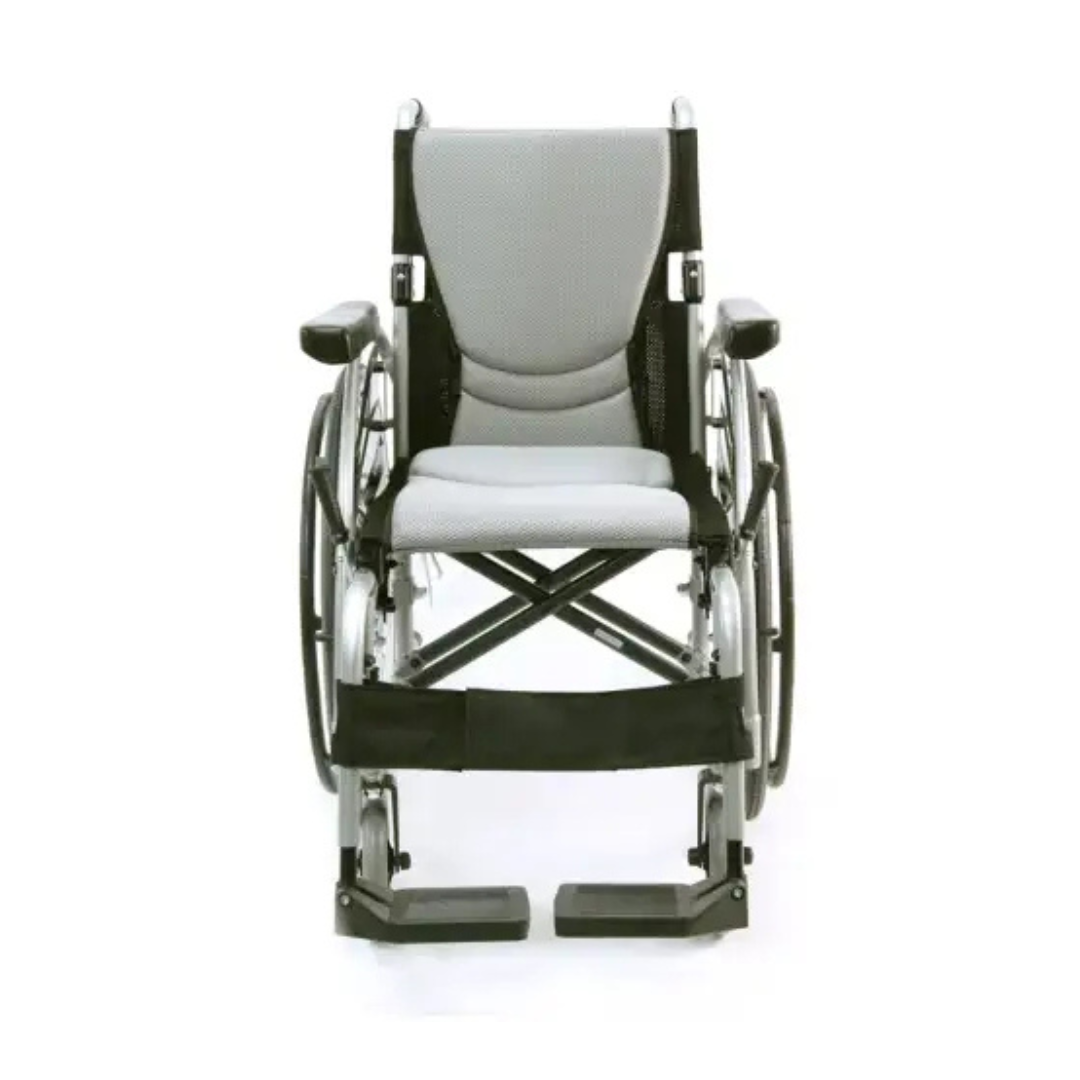 The Karman S-Ergo 125 wheelchair offers ergonomic seating and pressure relief. It features a silver frame, light gray seat and backrest, black armrests and footrests, and black wheels.
