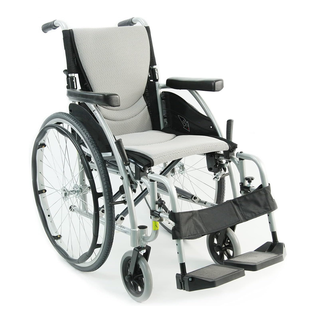 The Karman S-Ergo 115 Ultra Lightweight Ergonomic Wheelchair, at only 25 lbs, features a light gray frame with black armrests, footrests, and padded seat. It has two large rear wheels and two small front wheels for ergonomic comfort and easy maneuverability.