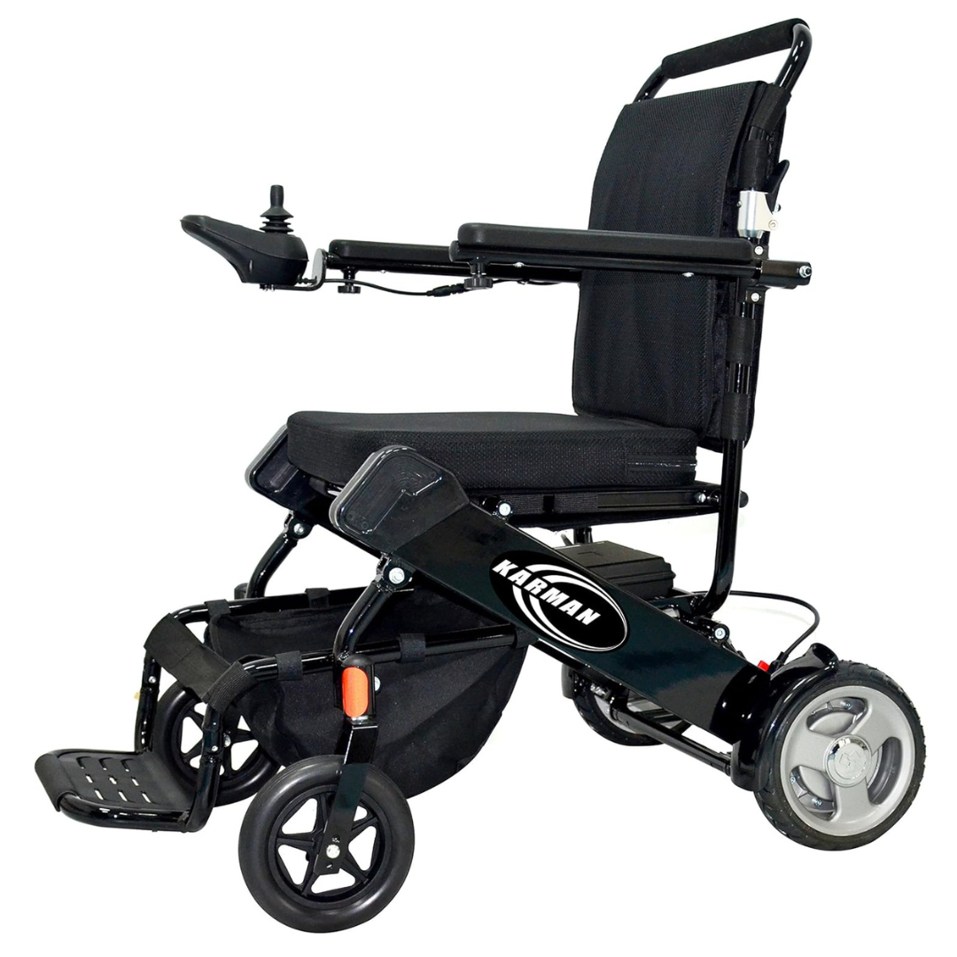 The FAA-approved Karman Tranzit Foldable Lightweight Power Wheelchair features a black frame and seat, a right-armrest joystick for control, gray wheels, a footrest, and an under-seat bag for convenience and easy transport.