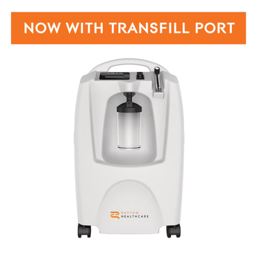 The Rhythm LM5BA 5L Stationary Oxygen Concentrator, in white with a clear canister and the Rhythm Healthcare logo, features a prominent orange "NOW WITH TRANSFILL PORT" banner—perfect for at-home oxygen therapy.