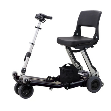 The FreeRider Luggie Classic II Travel Scooter is a compact, airline-approved scooter with a foldable design, black seat, handlebars, four wheels, and a small black bag at the base—ideal for convenient travel anywhere.