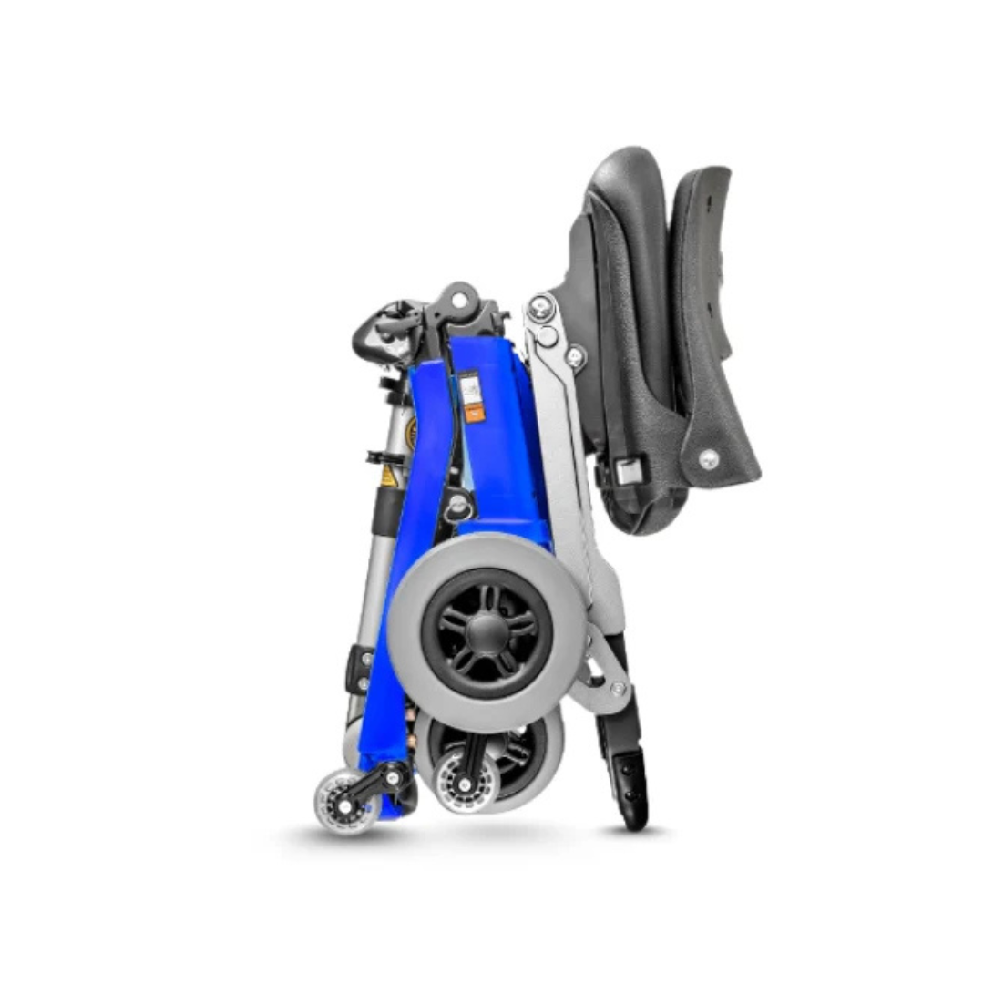 The FreeRider Luggie Elite Travel Scooter, in folded blue and black form with large rear wheels and small front casters, stands upright on a white background.