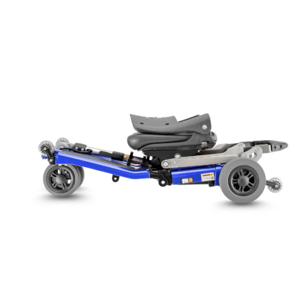 The FreeRider Luggie Elite Travel Scooter, in blue, folds compactly with wheels and seat neatly collapsed for easy transport or storage—making it perfect as an airline-approved scooter for convenient travel.