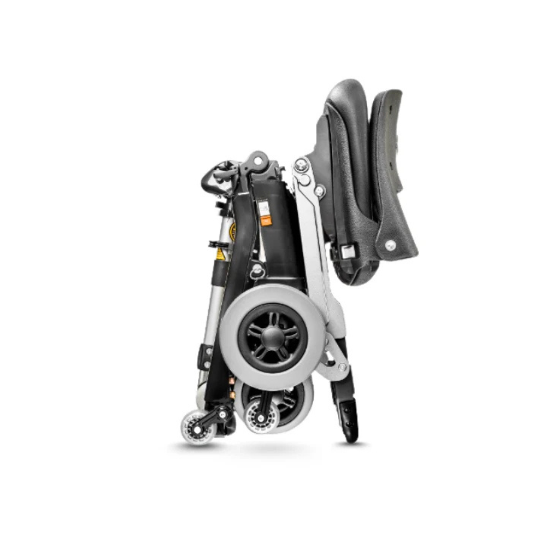 The FreeRider Luggie Elite Travel Scooter, shown folded in sleek black and gray, has its wheels and seat stacked compactly for easy storage or transport against a white background.