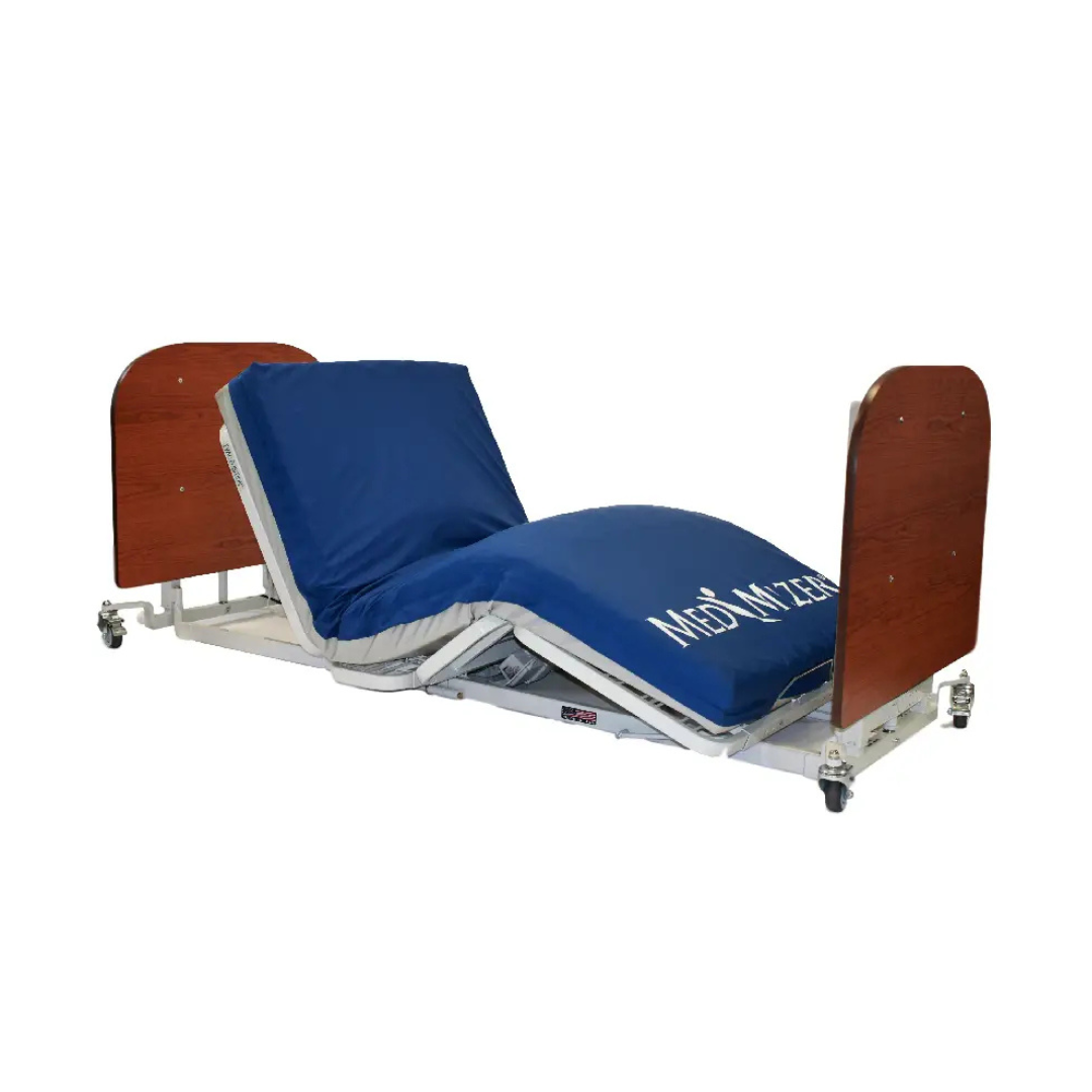 The Med-Mizer AllCare Full Electric Hi/Low Bed - Expandable Width features wooden head/footboards, blue bedding, a wheeled low frame, and an adjustable recline with elevated backrest and leg rest for comfort and easy positioning.