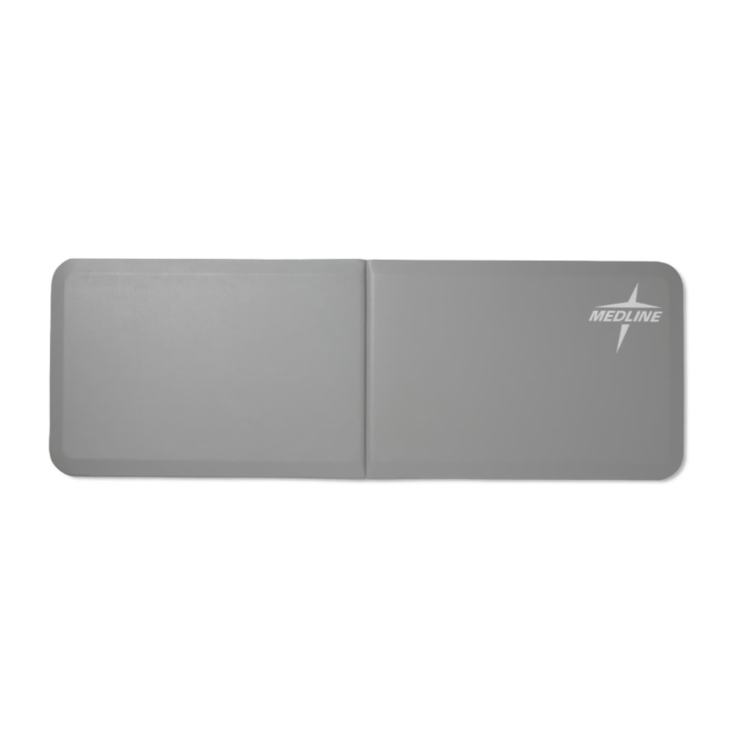 A gray Medline Bi-Fold Beveled Edge Fall Mat with rounded corners and white Medline logo, foldable for easy storage, is shown against a white background.