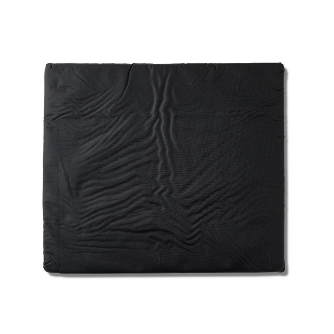 The Medline Comfort Foam Cushion, 3 thick, is a large black rectangular wheelchair cushion with a slightly wrinkled, textured surface shown against a white background.