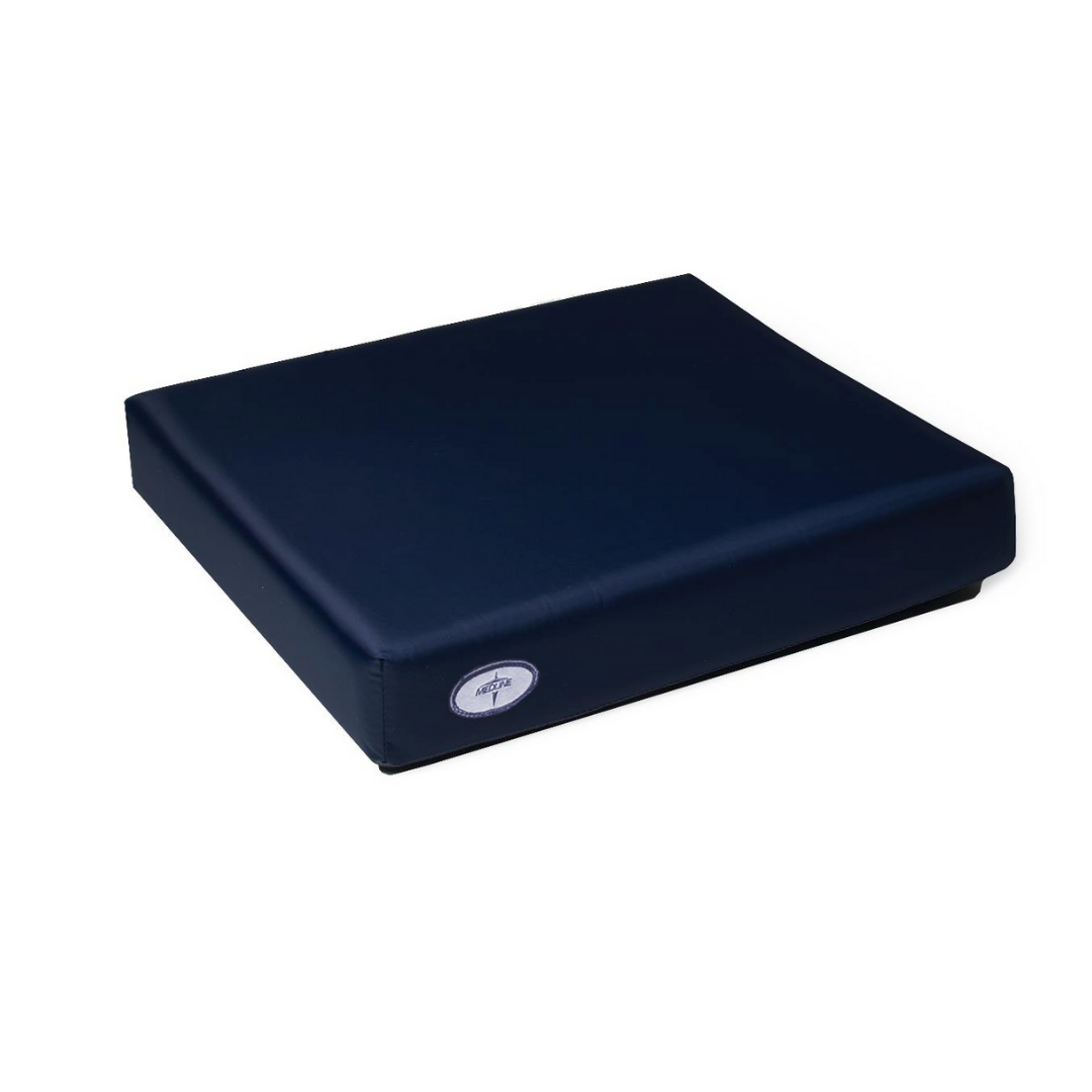 The Medline Comfort Foam Cushion, 3 thick, is a dark blue rectangular therapeutic seat cushion with a smooth cover and small circular side label, designed for pressure relief and shown against a plain white background.