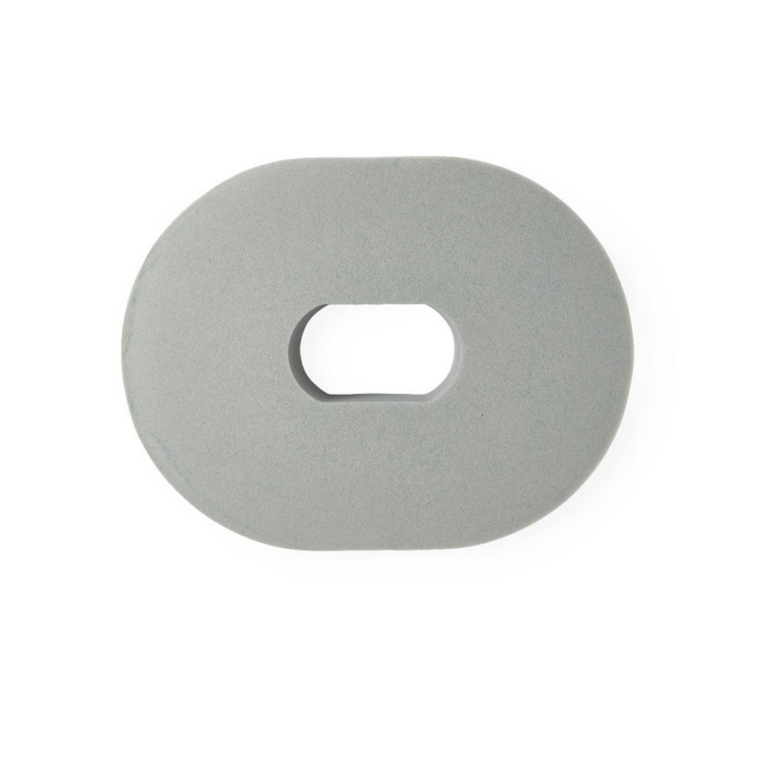 The Medline Compressed Foam Ring with Tailbone Cutout is a gray, oval cushion featuring a rectangular cutout in the center, shown from above on a white background.