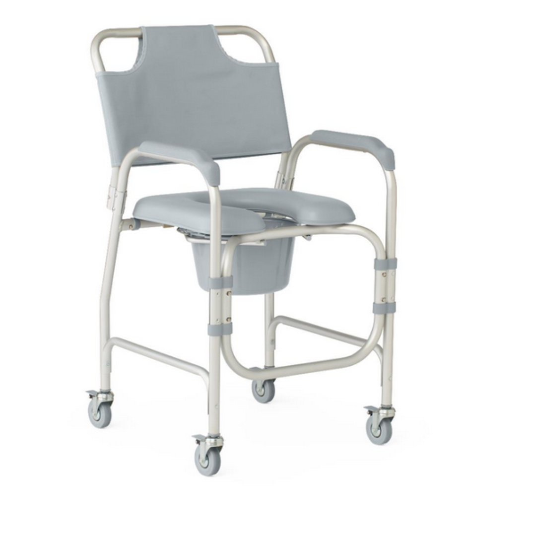 The Medline Drop-Arm Bedside Commode, with a light gray frame and padded armrests, features adjustable seat height for comfort. It includes four wheels for mobility and a removable commode bucket underneath.