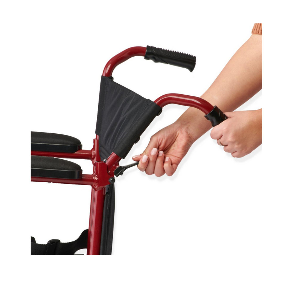 A person adjusts the brake cable of a red Medline Basic Aluminum Transport Chair with Fixed Full-Length Armrests, ensuring this durable mobility aid remains reliable for everyday use.