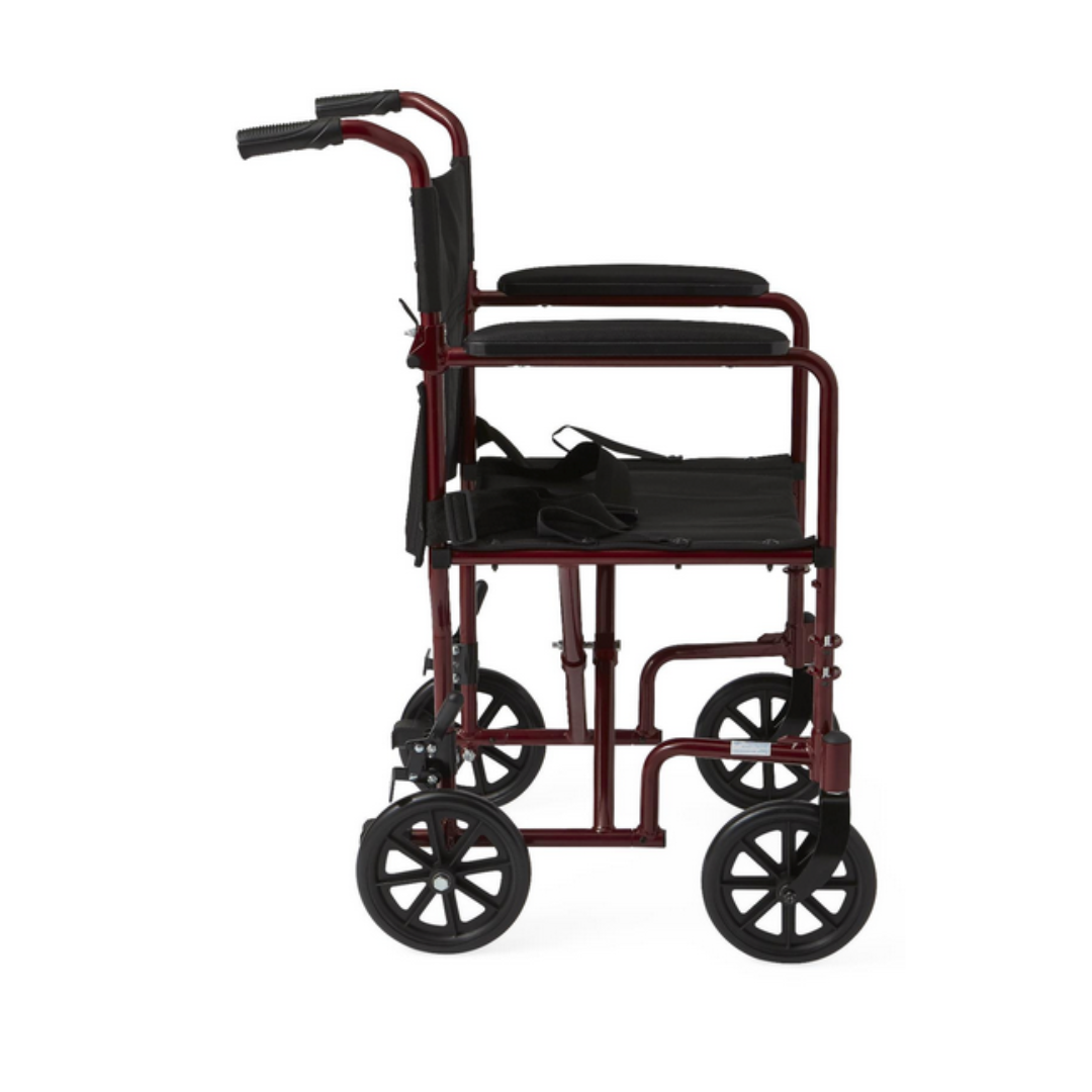 The Medline Basic Aluminum Transport Chair features a striking red frame, four black wheels, fixed full-length armrests, a black seat, and handles for easy pushing. This lightweight and durable wheelchair offers both style and functionality from the side view.