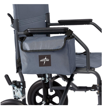 A close-up of a gray wheelchair with the Medline Side Bag for Transport Chairs & Wheelchairs, made from water-resistant nylon, attached to the armrest; part of the seat, wheels, and handles are visible.