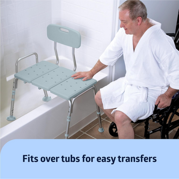 A man in a wheelchair uses the Medline Bath Transfer Bench with Microban for bathtub access. The bench offers adjustable height legs and a backrest for comfortable, easy transfers. The text reads: Fits over tubs for effortless transitions.