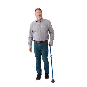 A middle-aged man with gray hair and a beard smiles in a gray shirt and jeans, holding a Medline TriGlide Stand-Alone Folding Cane with an ergonomic gel grip and blue pivoting base, against a white background.