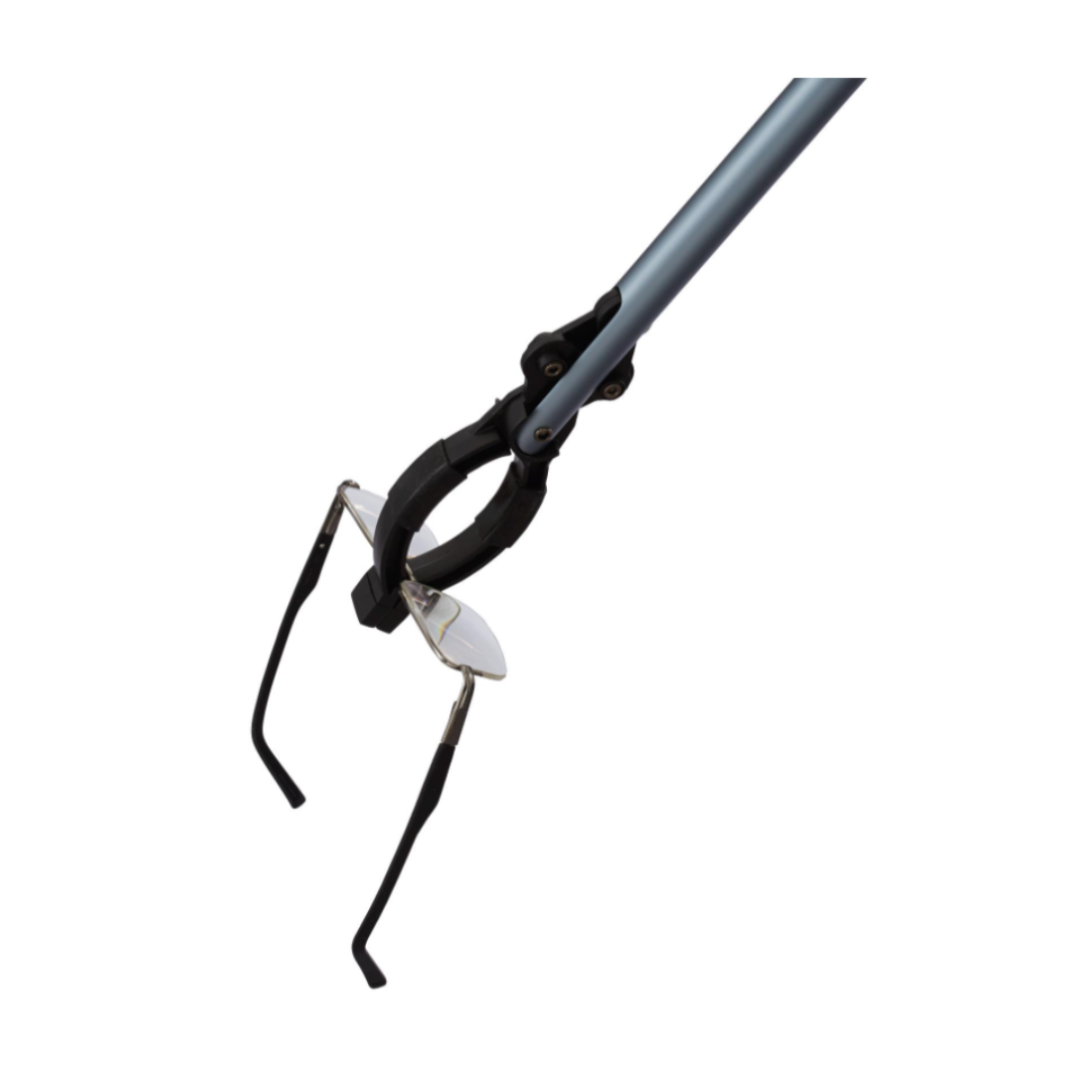 The Medline 31" Reacher Grabber Tool, featuring an ergonomic grip, securely holds eyeglasses by the temples, showing its effectiveness as a mobility aid for picking up small or delicate items.