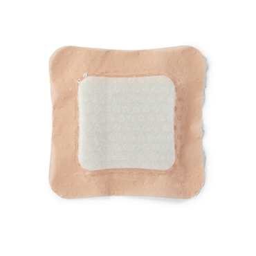 The Medline Optifoam Gentle SA Silicone-Faced Foam Wound Dressing is a square adhesive bandage with a raised white absorbent pad and peach-colored, textured border featuring gentle silicone adhesive, shown on a white background.