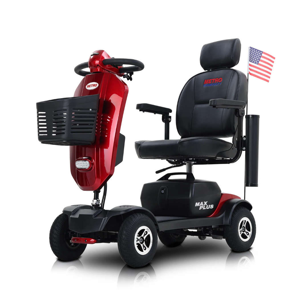 The metro Mobility MAX Plus Scooter is a red, four-wheel model with a black seat, front basket, 300W motor, and up to 16-mile range. It displays an American flag on a rear pole, with METRO on the seat and MAX PLUS on the base.