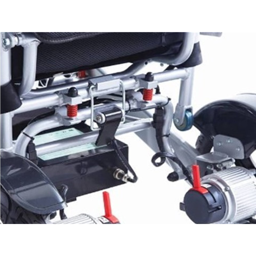 Close-up of the lower rear of the Miracle Mobility Platinum 8000 Portable Powerchair - Open Box, highlighting suspension springs, motor, wiring, battery box, and adjustment levers—ideal for travel-friendly mobility.