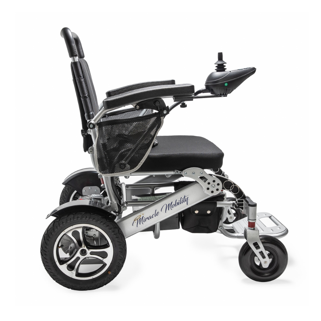 The Miracle Mobility Platinum 8000 Portable Powerchair - Open Box is a sleek, lightweight electric wheelchair with armrest joystick control, durable wheels, mesh side pocket, and signature branding, displayed in a side profile view.