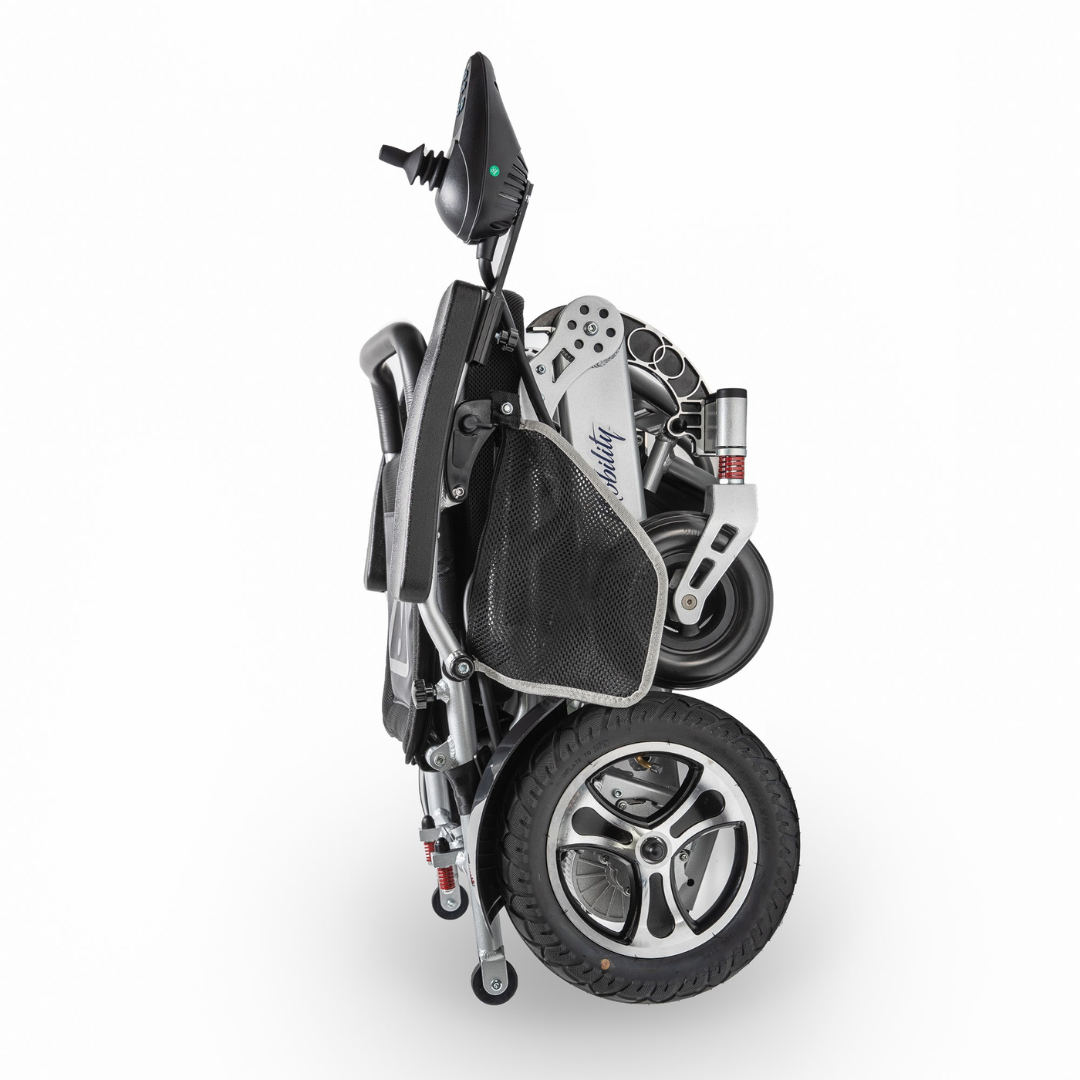 The Miracle Mobility Platinum 8000 Portable Powerchair - Open Box is shown folded upright against a plain white background, highlighting its compact design, two large wheels, mesh side pocket, and armrest control panel.