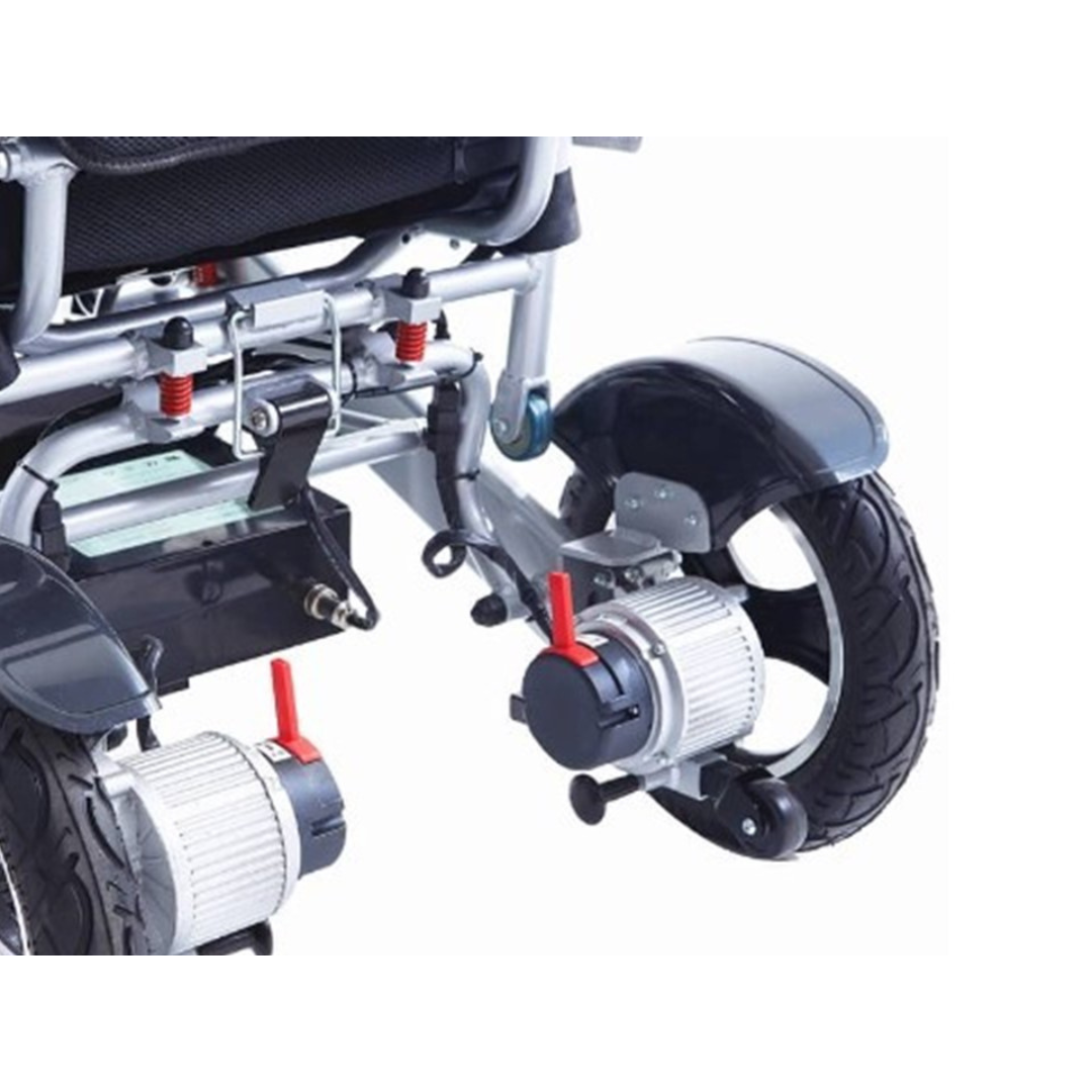 Close-up of the rear wheel and motor assembly of the Miracle Mobility Platinum 8000 Portable Powerchair - Open Box, highlighting mechanical details, suspension springs, wiring, and black tires on this travel-friendly wheelchair.