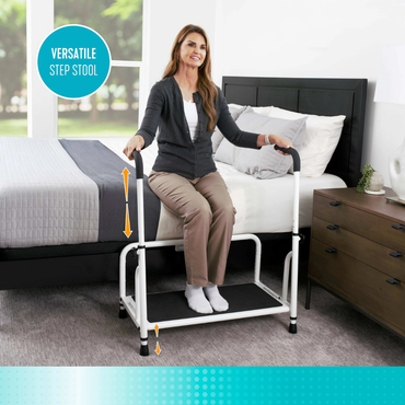 A woman uses the Stander Step Bedside Platform with LED Lighting, a sturdy white safety step with handlebars on each side, to rise from bed. Text reads “Versatile Step Stool.”.