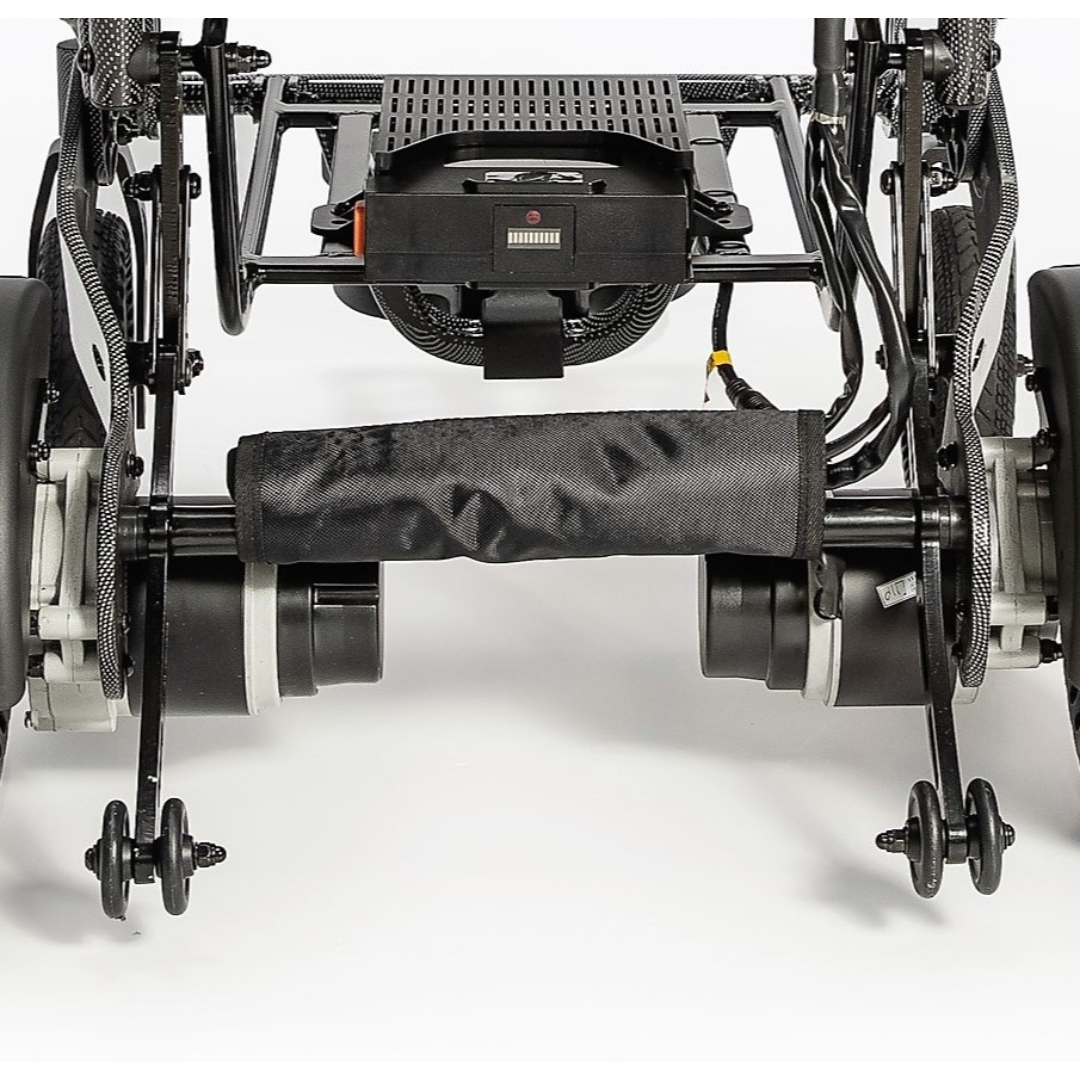Close-up of the rear wheels and motor components of the Miracle Mobility Palladium 8500 Portable Powerchair, highlighting detailed mechanical parts and wiring against a white background.