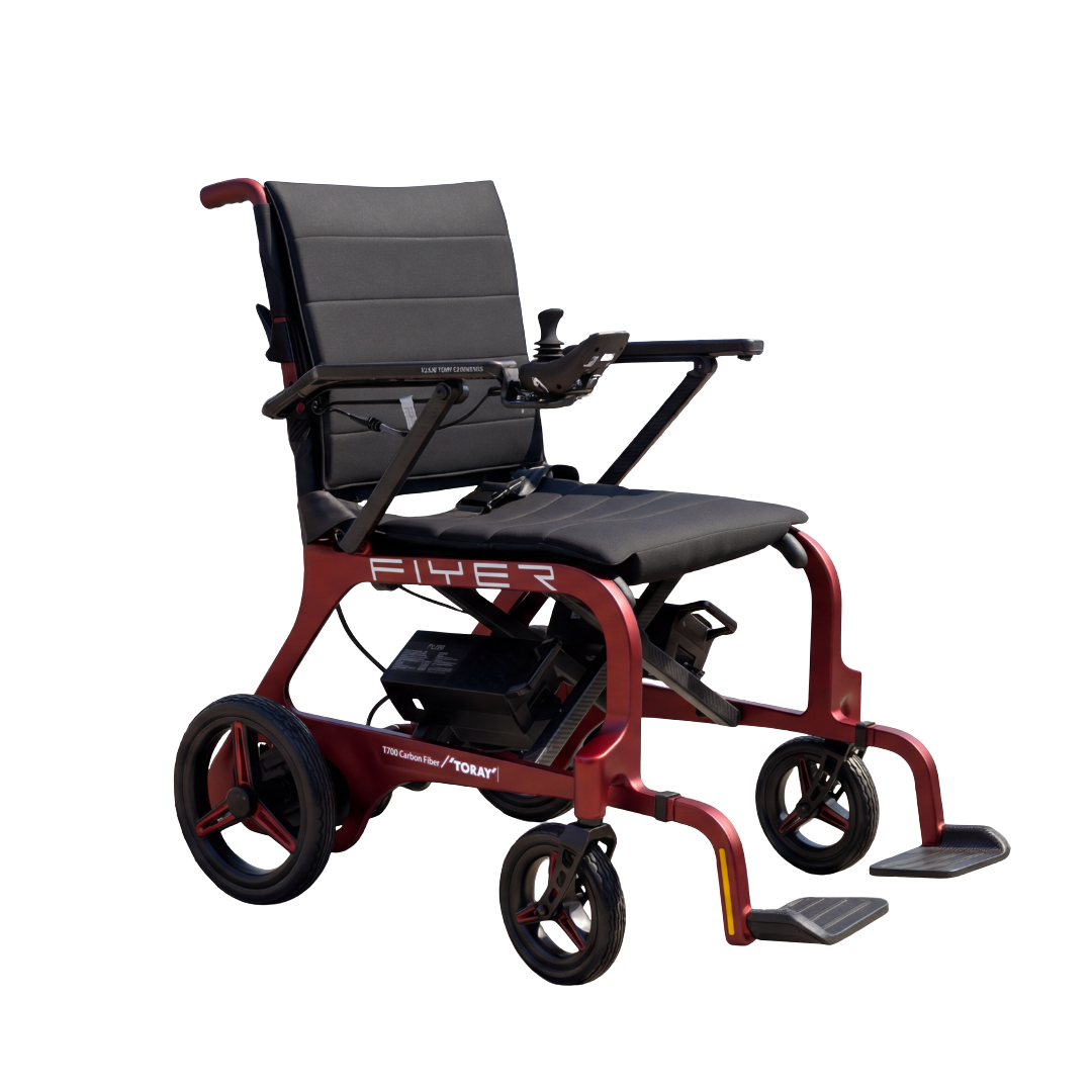 The Monarch Flyer Ultra-Lite Carbon Powerchair is a modern, lightweight red carbon fiber wheelchair with black seat and backrest, armrests, joystick controls, footrests, and large rear wheels on a white background.