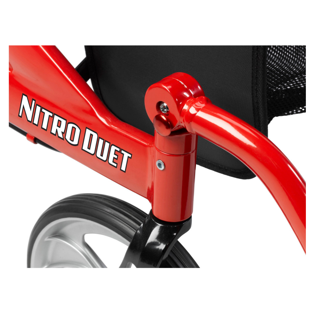 Close-up of a red Drive Hybrid Nitro® Duet Rollator and Transport Chair, highlighting part of the frame, a wheel, and a joint near the black mesh seat—an innovative mobility solution.