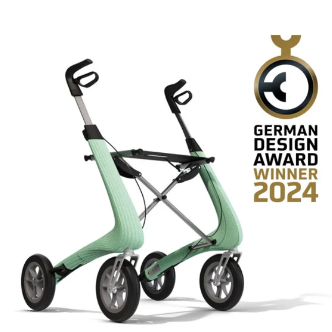 Light green byACRE Nordic Pioneer Lightweight Folding Rollator - Only 13 lbs, with four large wheels and ergonomic handles, is shown next to a German Design Award Winner 2024 emblem on a white background.