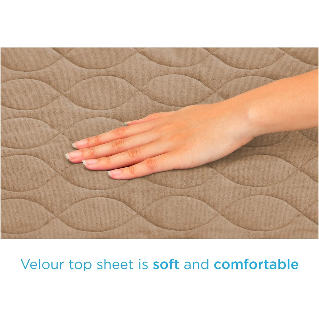 A hand gently touches the quilted, light brown velour surface of the Nova Ultra Reusable Waterproof Underpad For Chairs (21" x 22"). Text reads: Velour top sheet is soft and comfortable—perfect for reusable bed or chair pads.