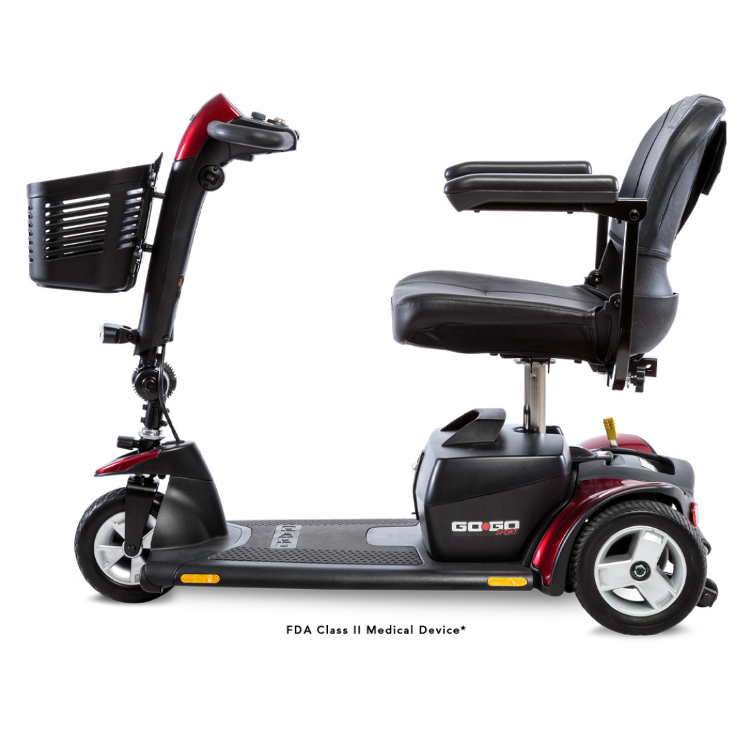 Side view of the Pride Go Go® Sport 3-Wheel Scooter in red and black, featuring a front basket, padded seat, and armrests. This compact mobility scooter is designed for personal transportation with customizable options to suit individual preferences.