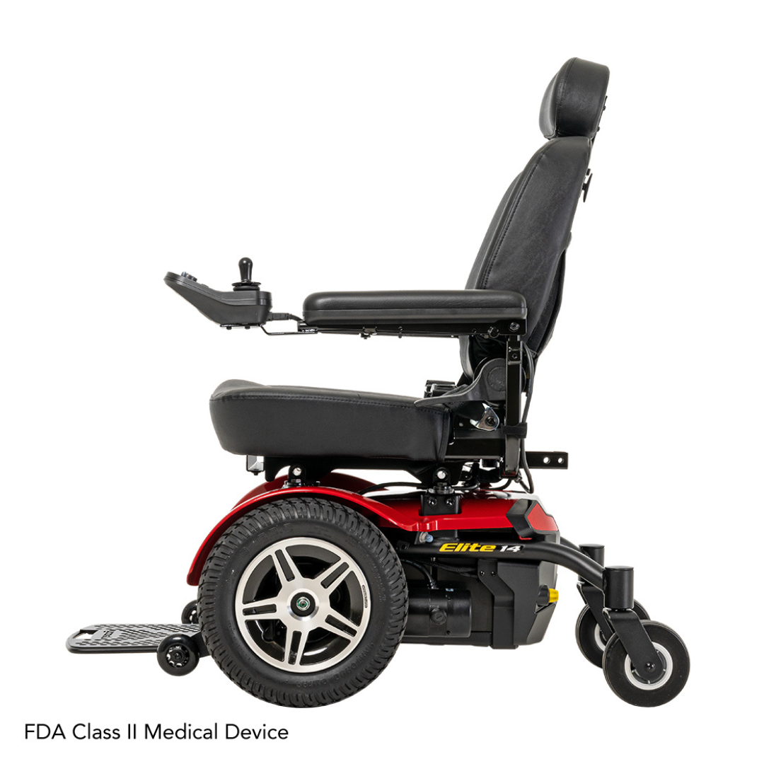 Side view of the Pride Jazzy® Elite 14 Powerchair, a red electric wheelchair with front-wheel drive, 14 knobby tires, a black cushioned seat, joystick control panel, large rear wheels, smaller front wheels, and a folded footrest. Classified as an FDA Class II Medical Device.