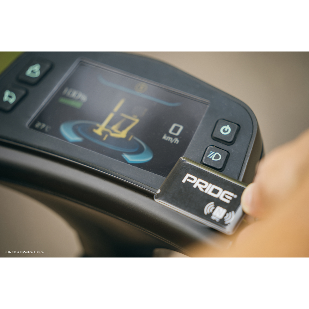 The electronic dashboard of the Pride Mobility GoGo Carbon Ultralite Mobility Scooter, weighing only 35 lbs, shows speed in km/h and illuminated controls on a screen, reflecting its sleek design and portability.