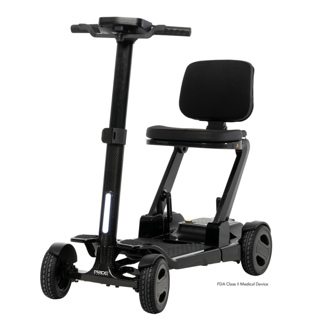 The Pride Mobility GoGo Carbon Ultralite Scooter, weighing just 35 lbs, is a black portable scooter featuring a modern design with a padded seat, steering handlebar, and four wheels for stability. Its lightweight and compact carbon fiber frame ensures easy transport.