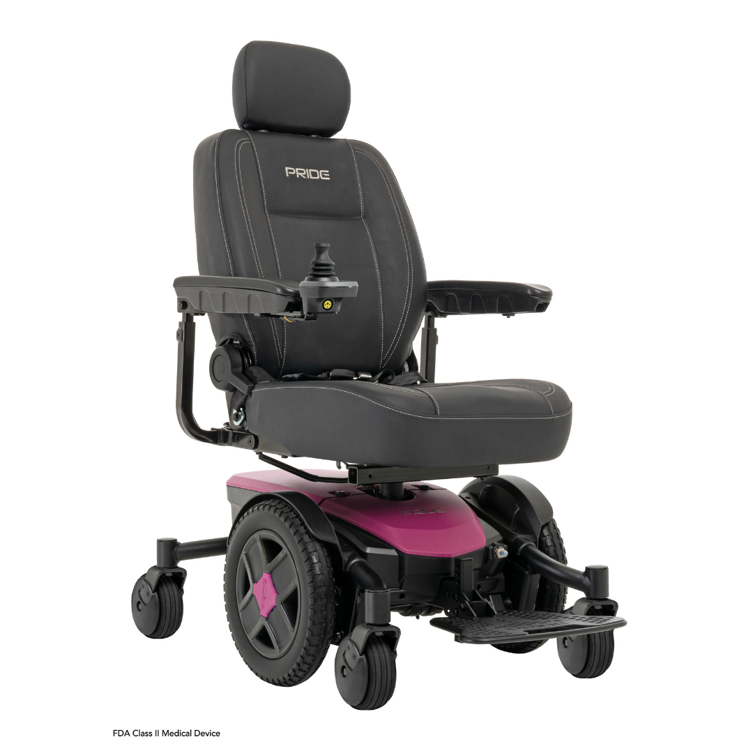 A black and pink Pride Mobility Jazzy® EVO 613 Powerchair with ATX Suspension features a padded seat, headrest, armrests, joystick control, footrest, four wheels, and Mid-Wheel 6® Technology. Pride is displayed on the backrest.