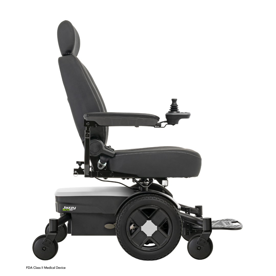 Side view of the Pride Mobility Jazzy® EVO 613 Powerchair with ATX Suspension in black, featuring a padded seat, backrest, armrests, footrest, right joystick control, large rear wheels, small front wheels, and Mid-Wheel 6® Technology.