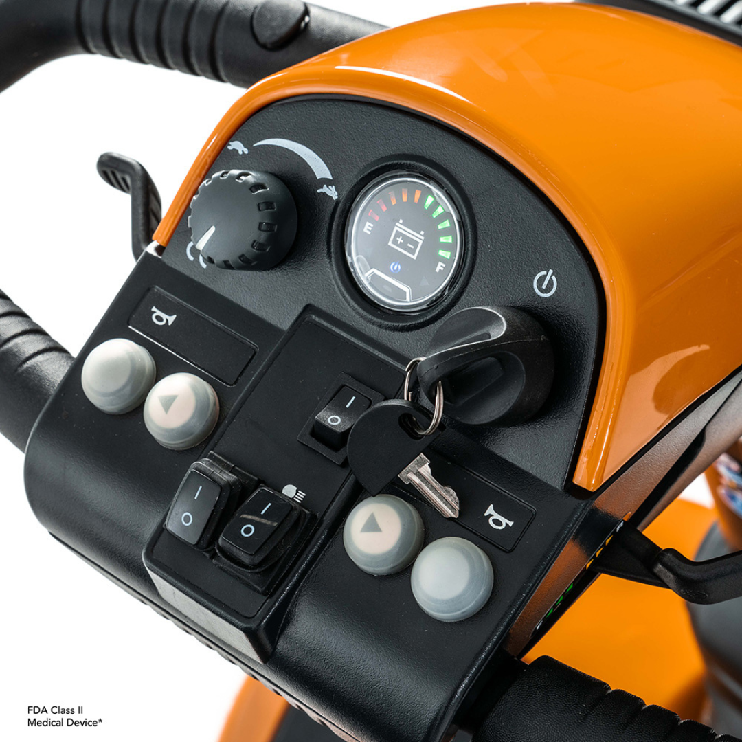 Close-up of the control panel on the Pride Mobility Pursuit® 2 Offroad HD Scooter, featuring a speed dial, battery indicator, ignition key, horn buttons, and various switches.