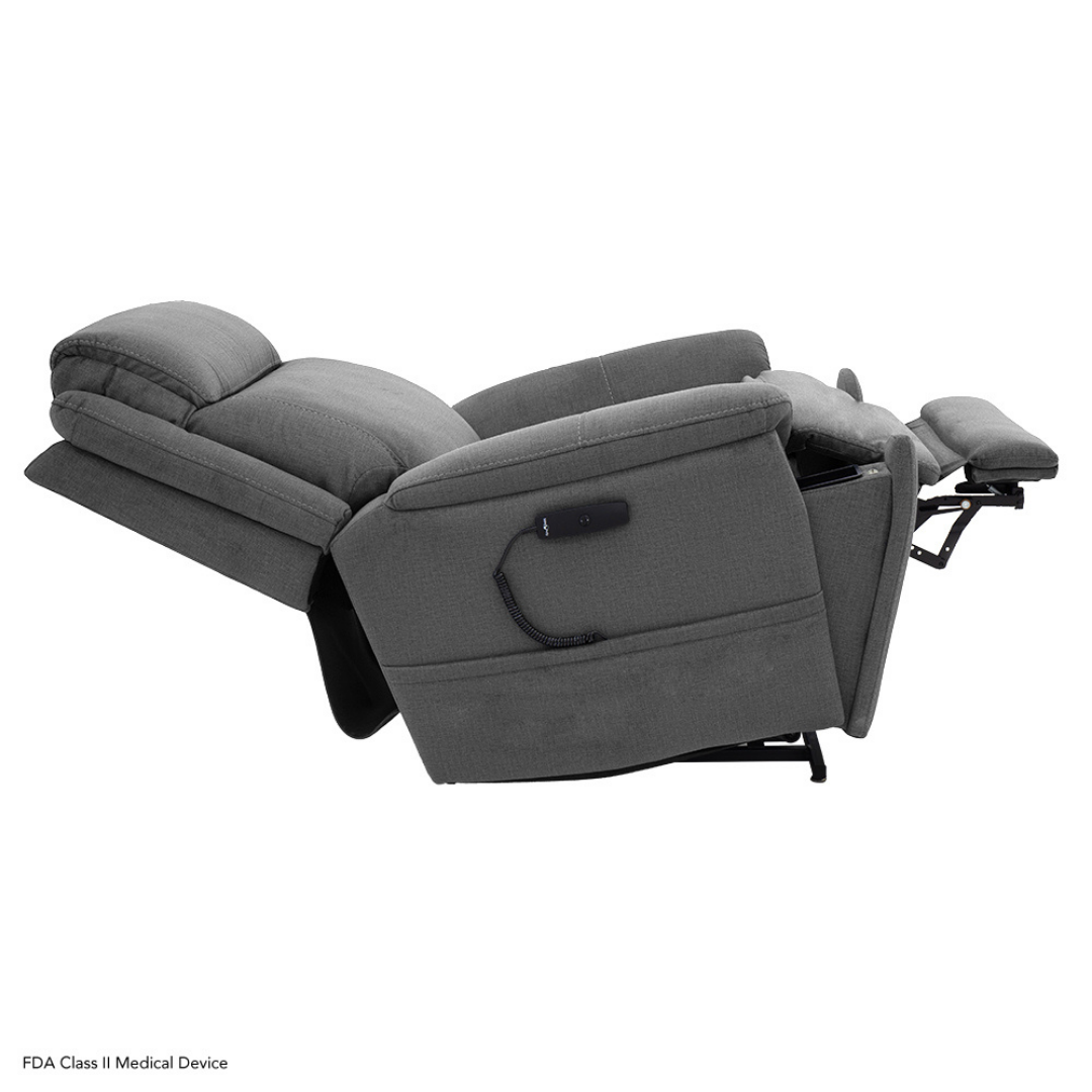 The Pride Mobility Evolution Collection Power Lift Recliner in gray is fully reclined with the footrest extended; an attached remote control showcases its premium features.